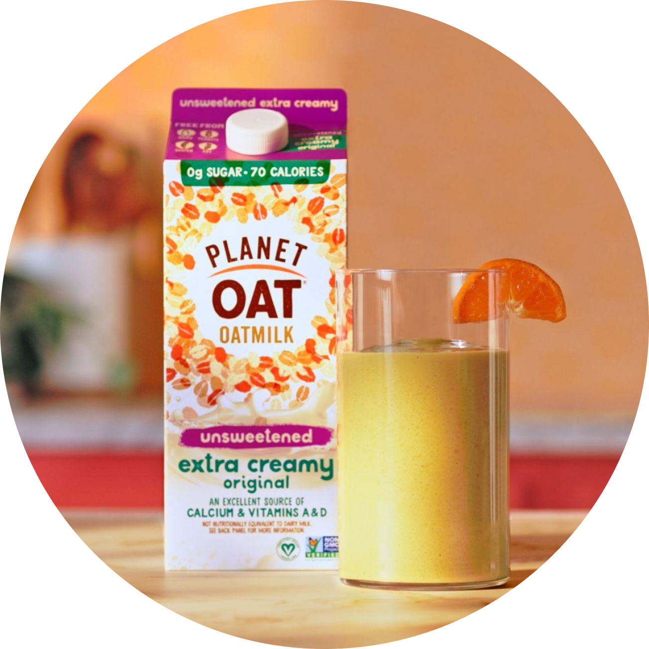 Planet Oat Unsweetened Extra Creamy Oatmilk with an orange smoothie