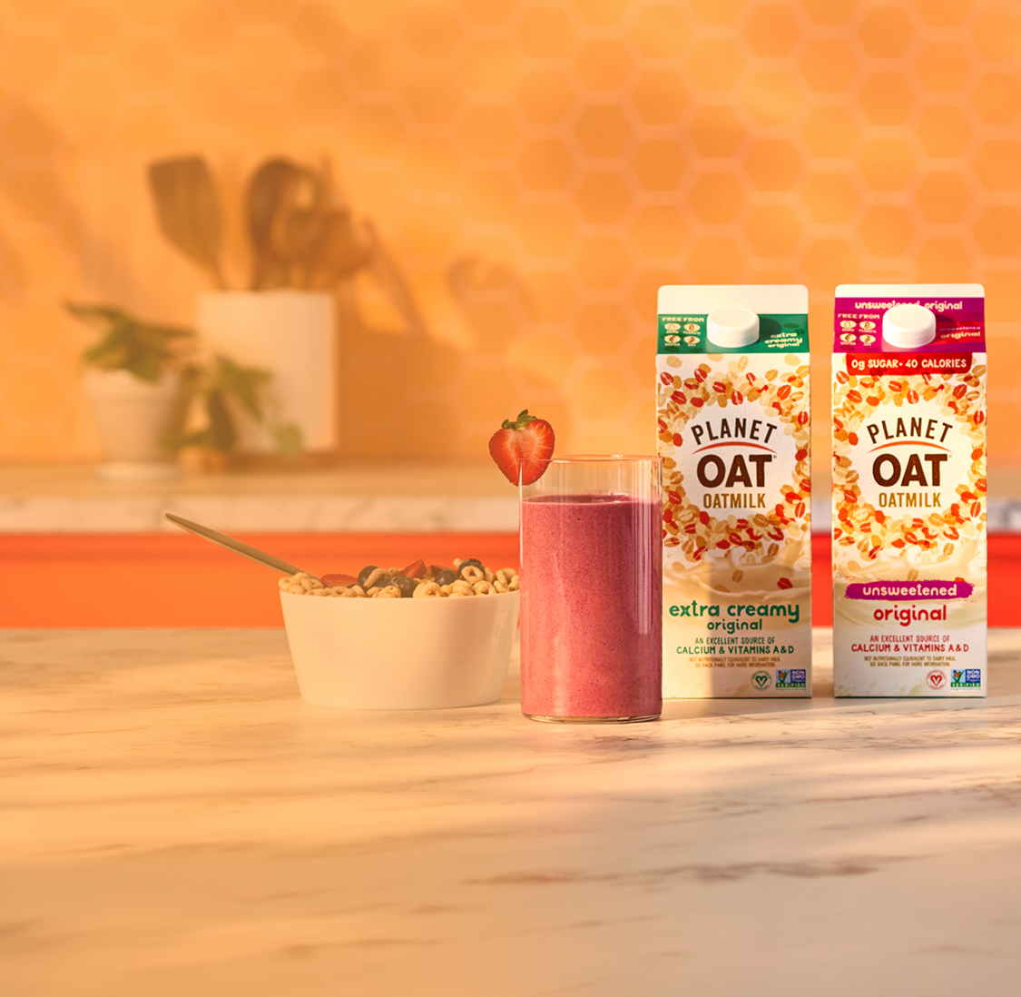 Planet Oat Oatmilk on a counter top next to a purple smoothie and a bowl of cereal